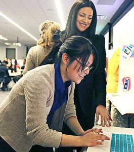 Young woman learning programming with female instructor